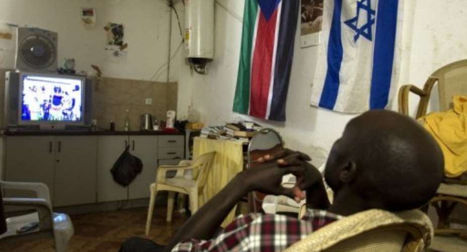 An African migrant from South Sudan watches television in Tel Aviv.  By Jack Guez AFPFile