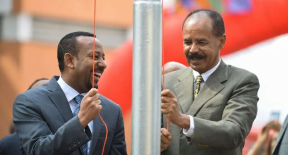 Issues remain despite the rapprochement between Ethiopian premier Abiy Ahmed L and Eritrean President Isaias Afwerki R, seen here at the July reopening of Eritrea's embassy in Addis Ababa.  By MICHAEL TEWELDE AFP