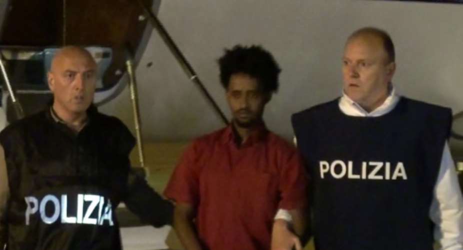 Italian police escort Medhanie Yehdego Mered, afte the alleged people smuggler was extradition from Sudan to Rome, on June 6, 2016.  By  Polizia di StatoAFPFile
