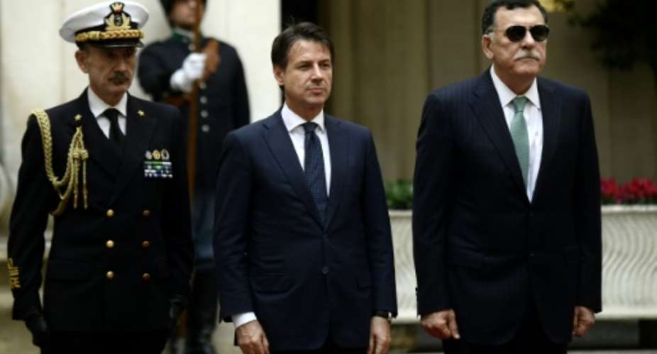 Italy's Prime Minister Giuseppe Conte C met his Libyan counterpart Fayez al-Sarraj in Rome in October.  By Filippo MONTEFORTE AFPFile