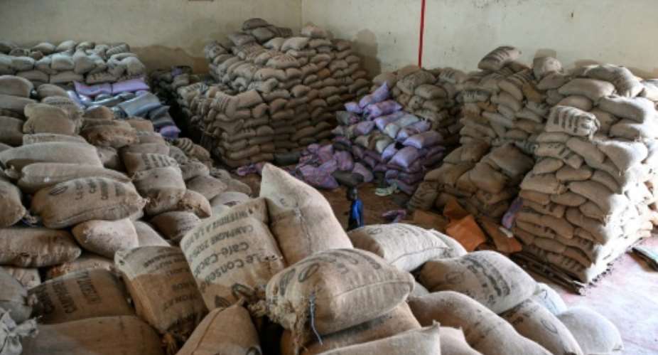 Ivorian cocoa growers complain of a hold-up in the export and sale of their crop, leading to a pile-up in warehouses.  By Sia KAMBOU (AFP)
