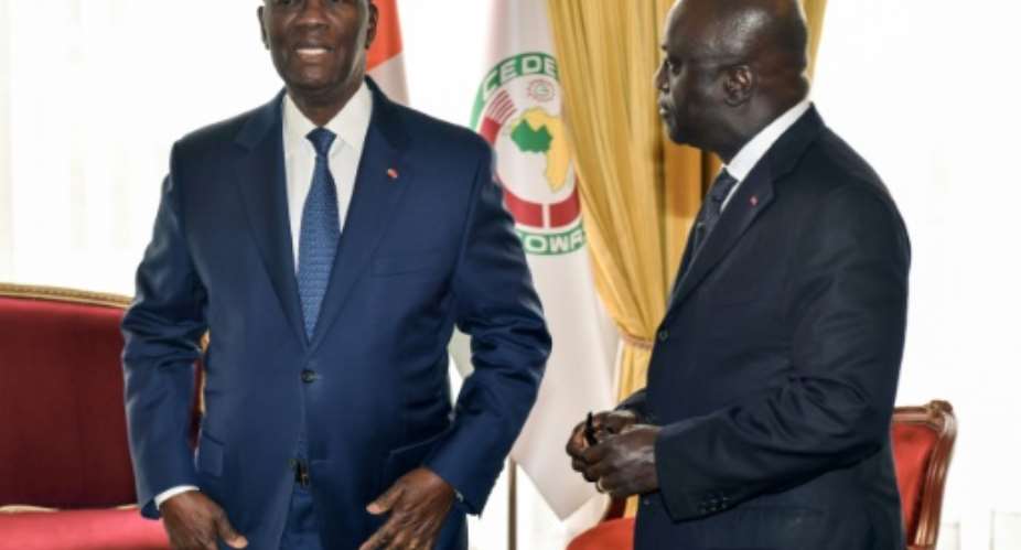 Ivorian President Alassane Ouattara, left, with the then foreign minister Marcel Amon-Tanoh, pictured in October 2018. Amon-Tanoh has declared his bid to succeed Ouattara as head of state.  By ISSOUF SANOGO AFP