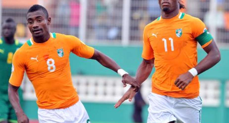Ivory Coast's national football team players Didier Drogba R and Salomon Kalou celebrate in Abidjan on October 12, 2013.  By Issouf Sanogo AFPFile