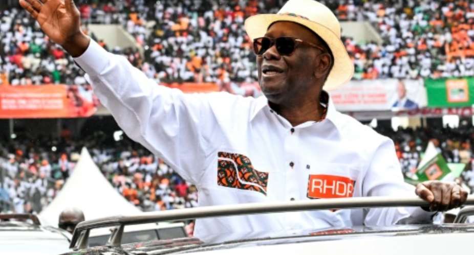 Ivory Coast President Alassane Ouattara waves to supporters.  By Sia KAMBOU (AFP)