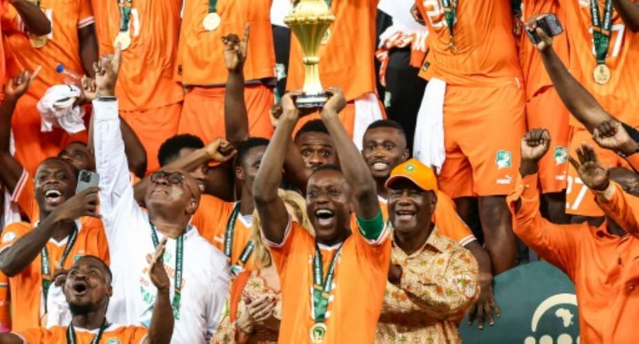 Ivory Coast's Max-Alain Gradel lifts the Africa Cup of Nations trophy aloft after Sunday's final victory against Nigeria.  By FRANCK FIFE AFP