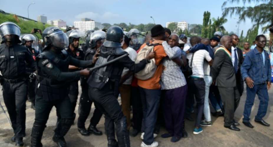 Ivory Coast's police officers arrest a members of the Ivory Coat's oppostion, among them Aboudramane Sangare 5R, one of country's opposition leaders, during a protest against a referendum on the adoption of a new constitution.  By Issouf Sanogo AFP