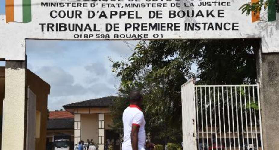 A man walks past the courthouse in Bouake on October 22, 2014 during the trial of a man found guilty of giving his 11-year-old daughter in marriage.  By Issouf Sanogo AFPFile