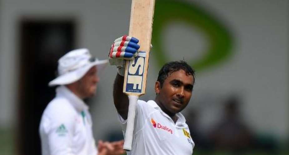 Sri Lanka's Mahela Jayawardene celebrates after scoring a century 100 runs during the opening day of the second Test against South Africa at the Sinhalese Sports Club SSC Ground in Colombo, on July 24, 2014.  By Lakruwan Wanniarachchi AFP
