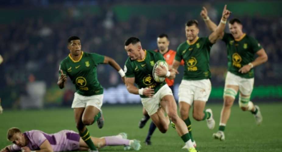 Jesse Kriel runs into score the clinching try as South Africa held off determined Scotland.  By PHILL MAGAKOE (AFP)
