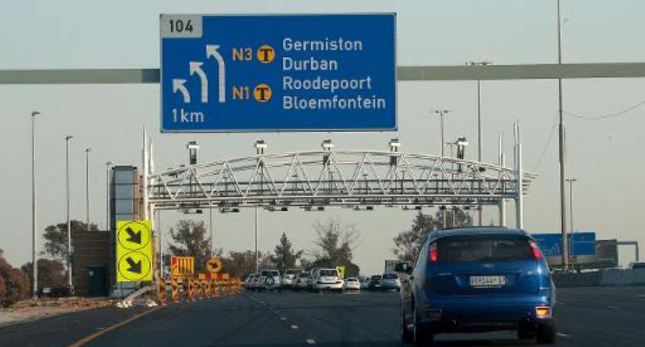 South African motorists drive towads the new electronic toll plaza on the highway from Pretoria to Johannesburg on July 9, 2011.  By Alexander Joe AFPFile