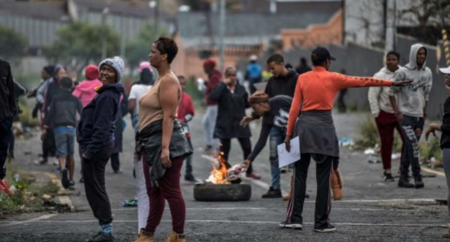 Johannesburg residents burn tyres on April 23, 2019 to protest the allocation of council services.  By MARCO LONGARI AFP