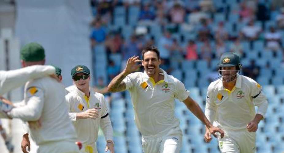 Mitchell Johnson C celebrates after bowling out South Africa's Graeme Smith in the first test match between South Africa and Australia at SuperSport Park in Centurion on February 13, 2014.  By Alexander Joe AFP