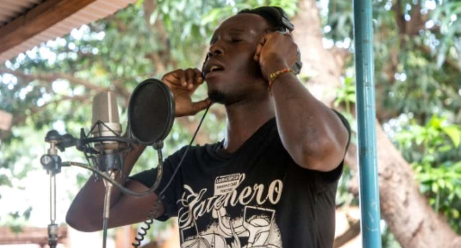 Jonathan Sougue, known as Johnyto, won a contest to record an album of songs inside the jail in Burkina Faso where he is serving a two-year term for being an accomplice to robbery.  By OLYMPIA DE MAISMONT (AFP)