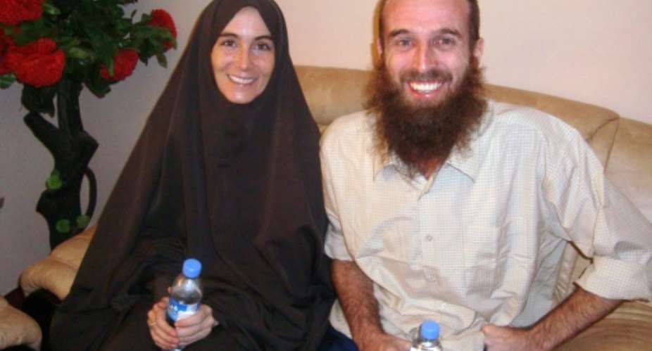 Journalists Amanda Lindhout from Canada L and Australian Nigel Brennan appear in this November 2009 released by the Somalian presidential office a few hours before their departure from Mogadishu airport at the end of a 15-month hostage ordeal.  By  SOMALIAN PRESIDENTIAL OFFICEAFPFile