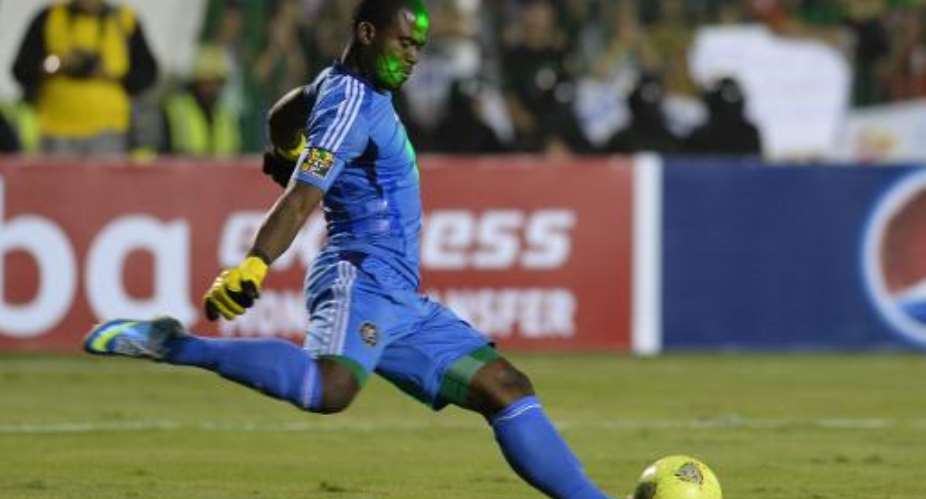 Senzo Meyiwa takes a goal kick for Orlando Pirates on November 10, 2013, in the CAF Champions League Final second leg against al-Ahly in Cairo.  By Khaled Desouki AFP