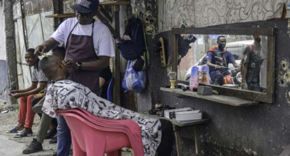 Kalume is one of thousands trying to make ends meet with an off-the-books job.  By Hardy BOPE (AFP)