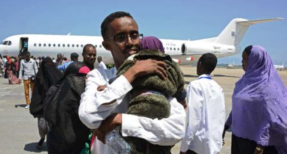 Somali refugees, deported from Kenya, arrive at Mogadishu Airport on April, 9, 2014.  By Mohamed Abdiwahab AFP
