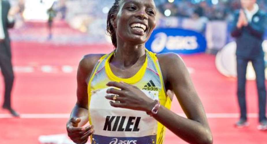 Kenya's Caroline Kilel crosses the finish line to win the Frankfurt Marathon in western Germany on October 27, 2013.  By Boris Roessler DPAAFPFile