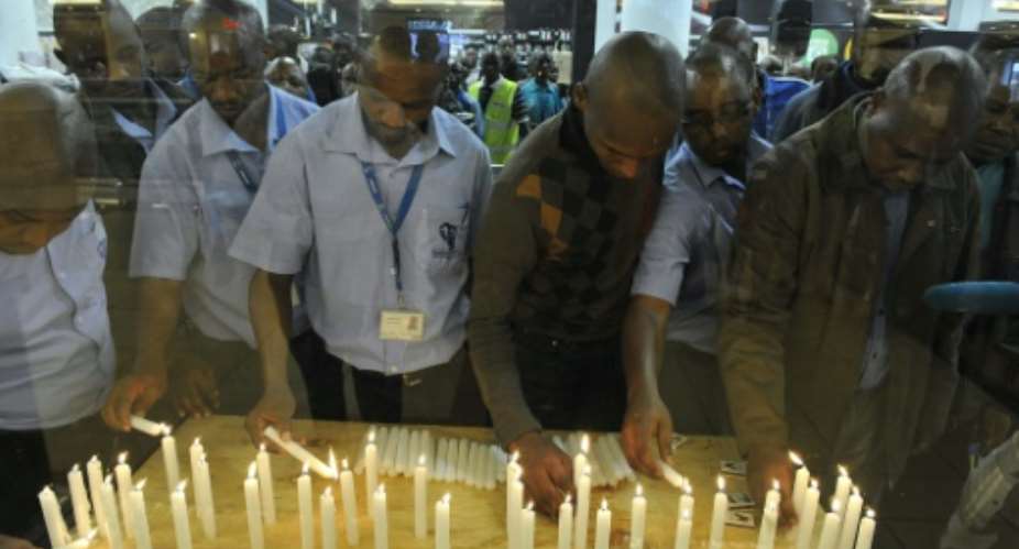 Kenyans light candles to mark the second anniversary of the Westgate shopping mall attack in Nairobi, on September 21, 2015.  By Simon Maina AFP