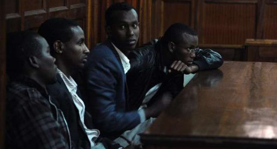 R-L: Adan Mohammed Abdikadir, Hussein Hassan Mustafa, Mohamed Abdi Ahmed and Omar Liban Adulle follow proceedings at the High Court in Nairobi on August 20, 2014 during a trial over their alleged role in the Westgate mall attack.  By Tony Karumba AFP