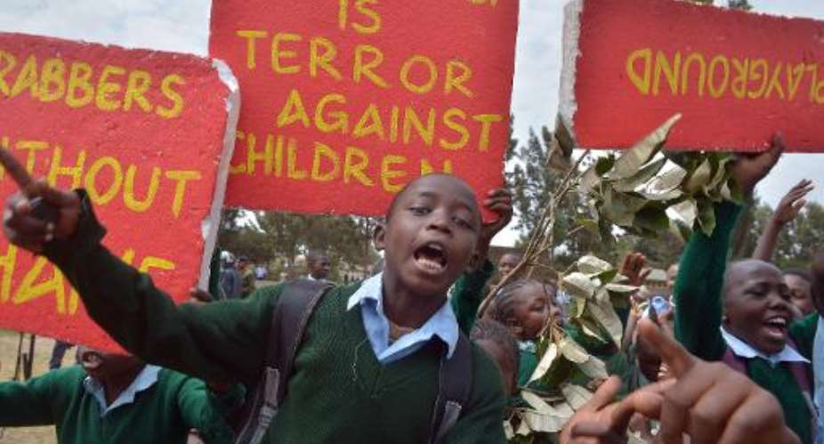 Pupils from the Lang'ata Road Primary School in Nairobi protest against the seizure of their playground by a property developer, on January 19, 2015.  By Tony Karumba AFP