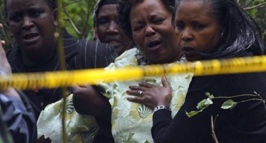 Relatives react as they arrive at the site of a police helicopter crash in the Ngong hills outside Nairobi.  By Simon Maina AFP