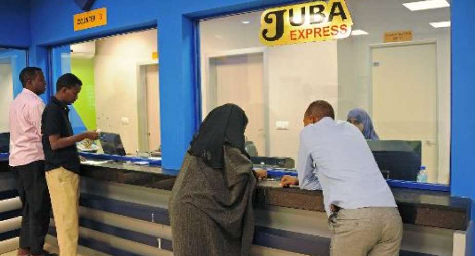 Customers wait to collect money at the Juba Express money transfer company in the Somali capital Mogadishu on February 12, 2015.  By Mohamed Abdiwahab AFPFile