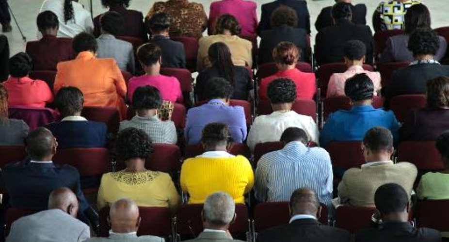 Kenyan mourners attend a prayer service held at St. Andrews Church in Nairobi on September 26, 2013.  By Georgina Goodwin (AFP)