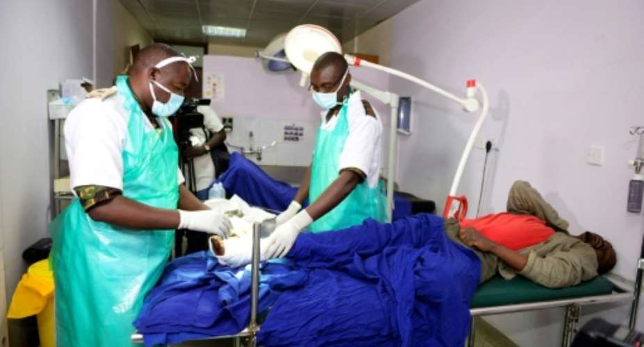 Kenyan Defence force doctors attend to an injured man at Kenyatta National Hospital in Nairobi in December 2016.  By JOHN MUCHUCHA AFPFile