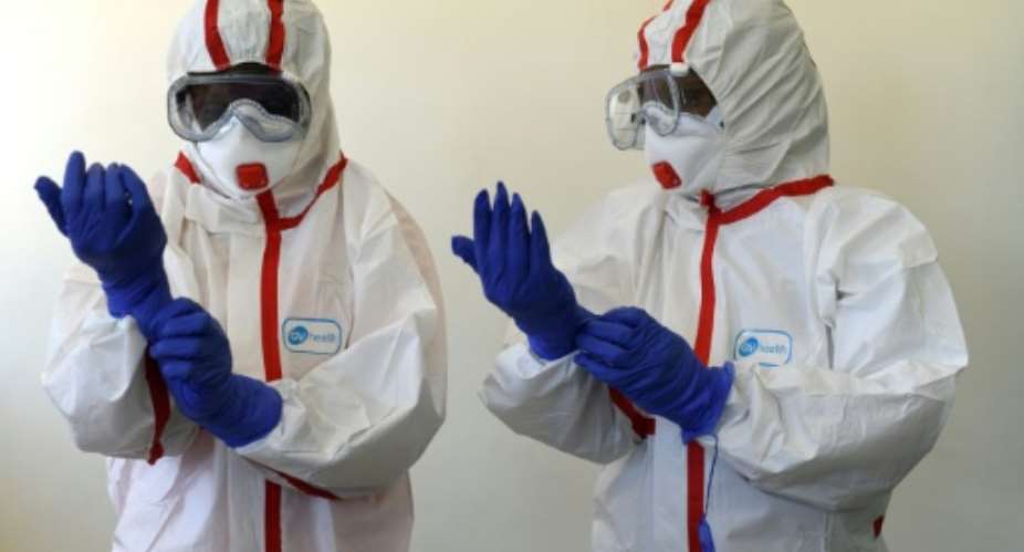 Kenyan health workers prepared with protective suits after east Africa reported its first cases.  By SIMON MAINA AFP