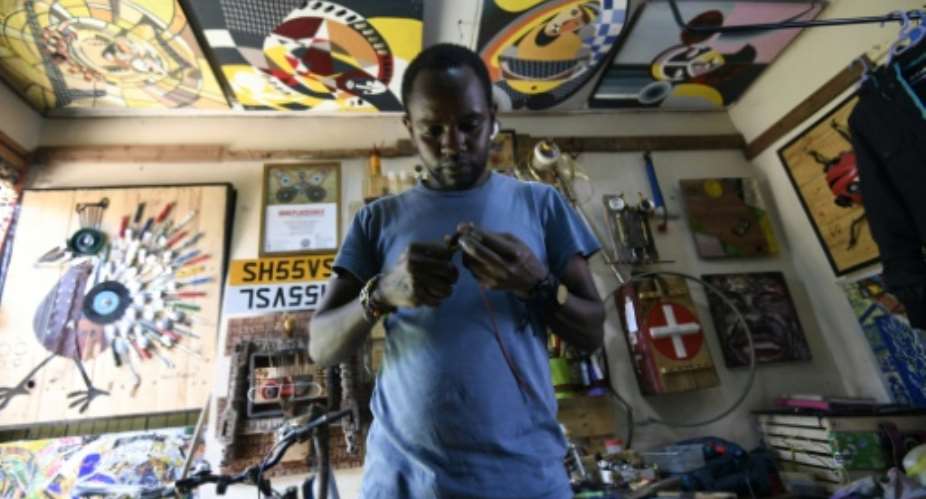 Kenyan junk artist Evans Ngure makes his sculptures out of found objects.  By SIMON MAINA AFP