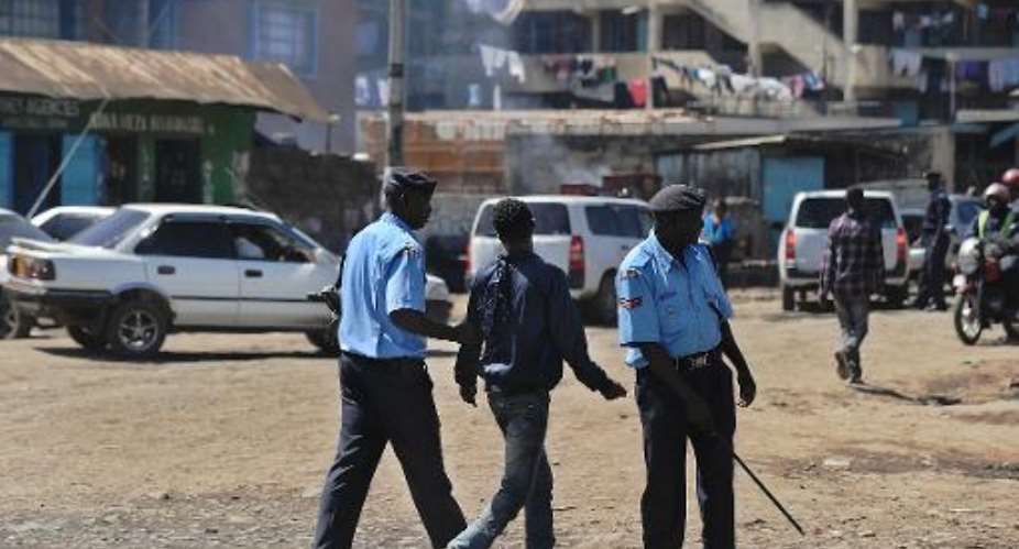 Police officers arrest a man for lack of identification documents in the somali district of Eastleigh in Nairobi, on April 9, 2014.  By Tony Karumba AFPFile