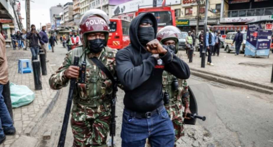 Kenyan police detain a protester in the capital Nairobi.  By SIMON MAINA (AFP)