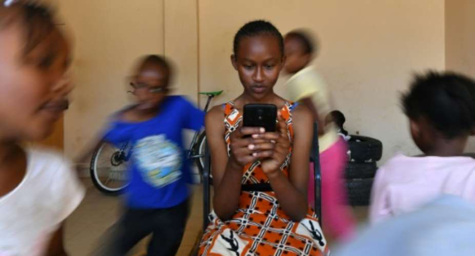 Kenyan schoolgirl Imelda Mumbi uses Eneza, an interactive educational app which has about three million users worldwide.  By TONY KARUMBA AFP