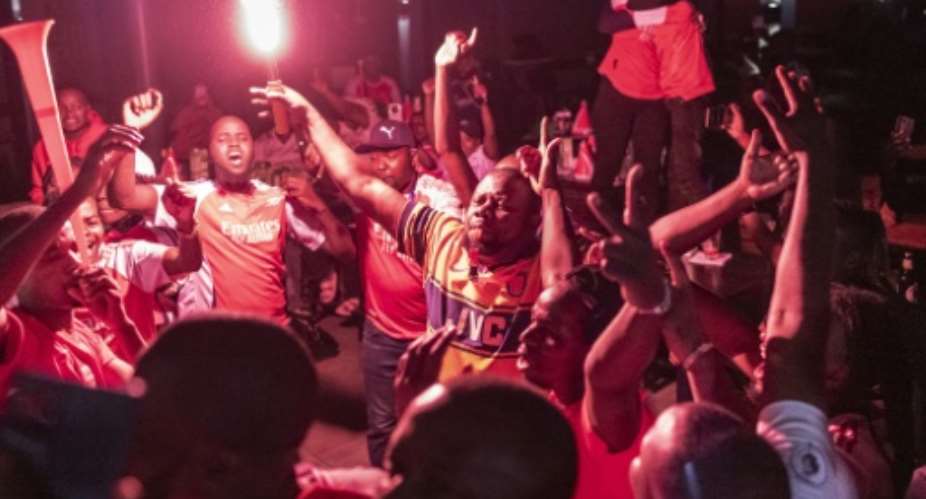 Kenyans go wild as Arsenal earn a place in the Champions League final.  By Tony KARUMBA (AFP)