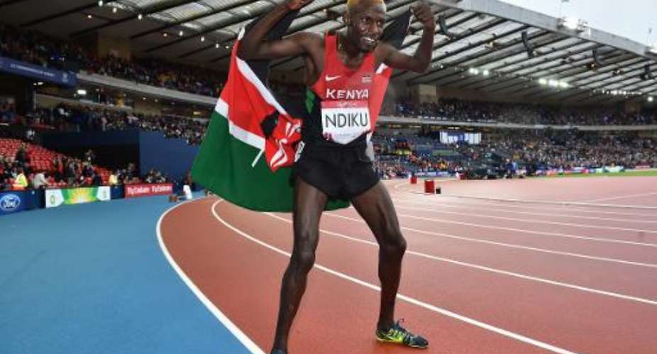 Kenya's Caleb Mwangangi Ndiku celebrates winning the final of the men's 5000m athletics event at Hampden Park during the 2014 Commonwealth Games in Glasgow, Scotland on July 27, 2014.  By Ben Stansall AFP
