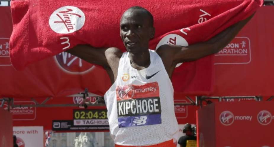 Kenya's Eliud Kipchoge celebrates after winning the men's race at the 2018 London Marathon.  By Daniel LEAL-OLIVAS AFP