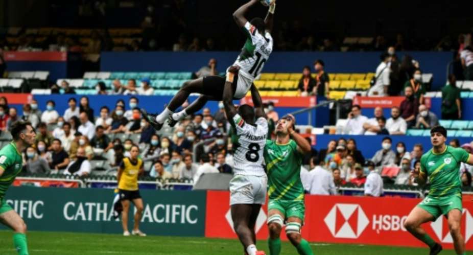 Kenya's Johnstone Olindi top is lifted by teammate Herman Humwa C against Ireland in the Hong Kong Sevens rugby tournament on November 4, 2022..  By ISAAC LAWRENCE AFP