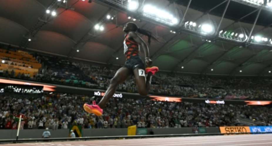 Kenyas Mary Moraa skips for joy as she crosses the line to win the womens 800m world title.  By Jewel SAMAD (AFP)