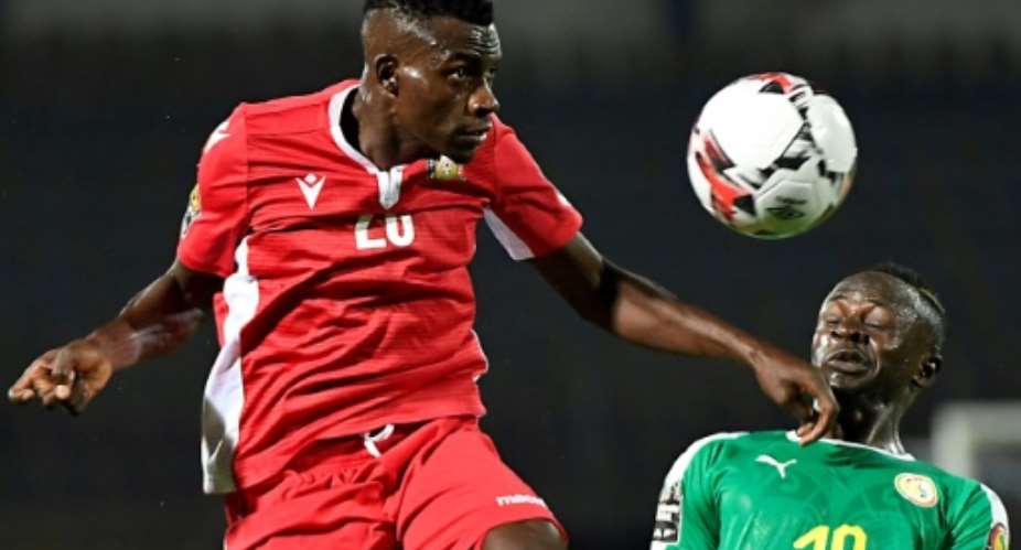 Kenya's midfielder Philemon Otieno L heads the ball next to Senegal's forward Sadio Mane.  By Khaled DESOUKI AFP