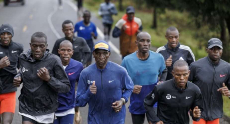 Kenya's Olympic marathon champion Eliud Kipchoge centre runs with fellow athletes in Kaptagat.  By Tony KARUMBA AFP