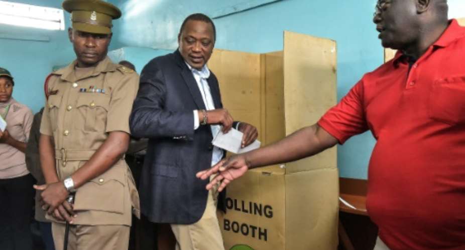 Kenya's President Uhuru Kenyatta easily won the October 26 vote in a vote upheld by the Supreme Court -- but barely one in three of the electorate voted following an opposition boycott in a country deeply divided.  By SIMON MAINA AFPFile