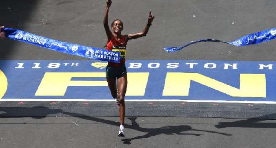 Rita Jeptoo of Kenya crosses the finish line to win the Women's Elite division of the 118th Boston Marathon in Boston, Massachusetts April 21, 2014.  By Timothy A. Clary AFP