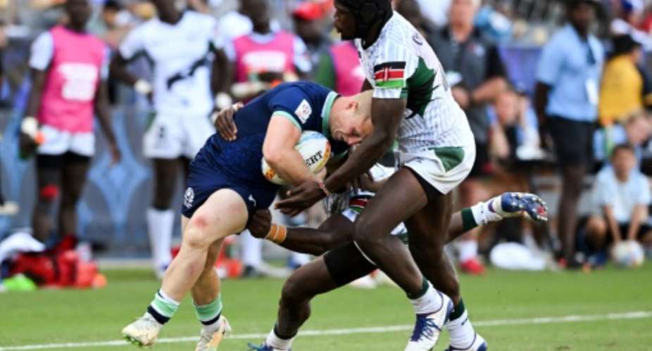 Kenya's Willy Ambaka C and Vincent Onyala R tackle Scotland's Reiss Cullen in the World Rugby Sevens Series event in Carson, California on August 27, 2022..  By Patrick T. FALLON AFP
