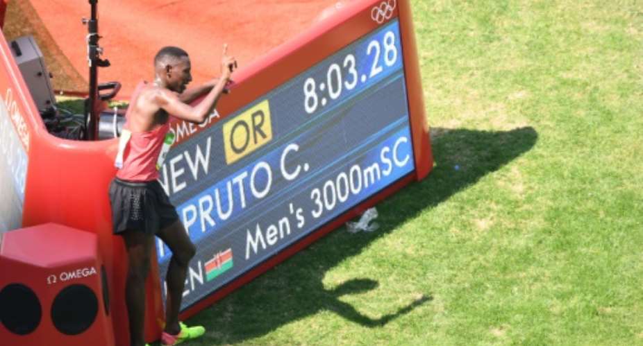 Kenya's Conseslus Kipruto celebrates his new Olympic record time on his way to victory in the men's 3000m steeplechase in Rio on August 17, 2016.  By Johannes Eisele AFP