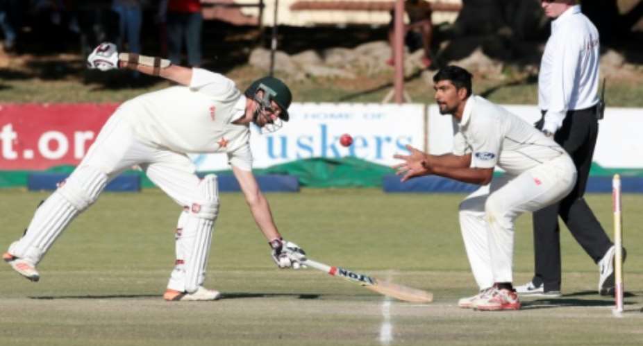 New Zealand's bowler Ish Sodhi right fields as Craig Ervines makes his ground during the third day of the second Test match in Bulawayo on August 8, 2016.  By Jekesai Njikizana AFPFile