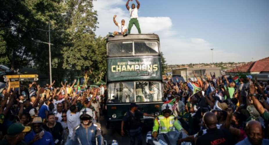 Kolisi stands proud on board the victory bus in Soweto.  By Michele Spatari AFP