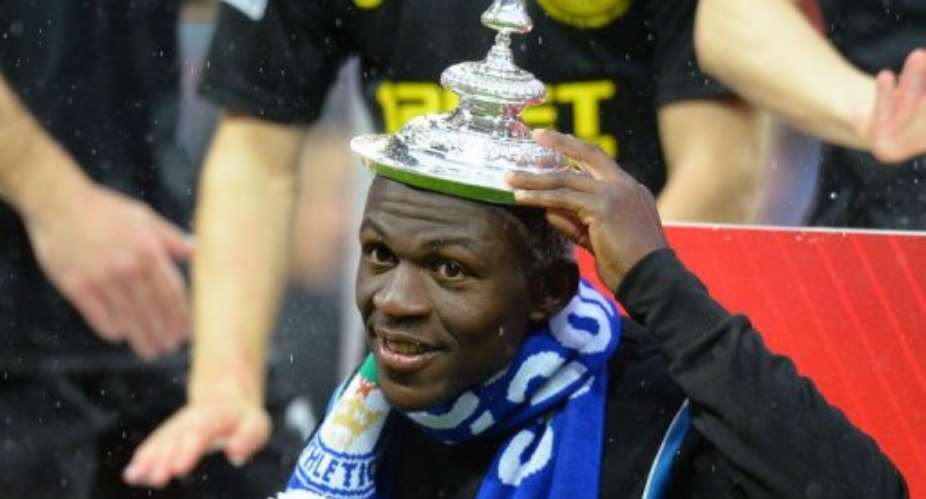 Arouna Kone poses with the lid of the FA Cup on his head at Wembley Stadium in London on May 11, 2013.  By Andrew Yates (AFP/File)