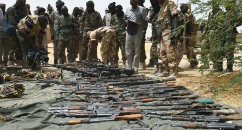 Chad soldiers display arms captured from Boko Haram militants on April 3, 2015 in Malam Fatori, in northeastern Nigeria.  By Philippe Desmazes (AFP)