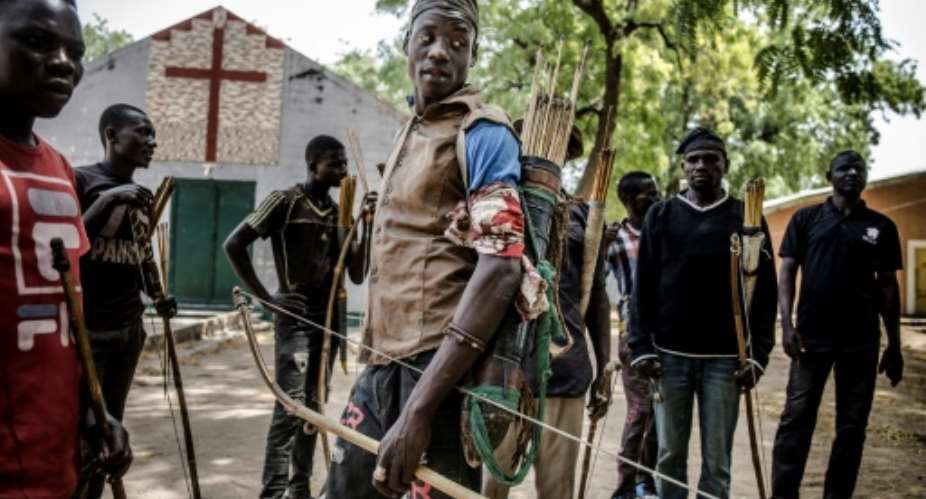 Land of tensions: Hunters armed with bows and arrows gathered in Dasso, central Nigeria, in February pledging to defend farmers in conflict with nomadic herdsmen.  By Luis TATO AFP